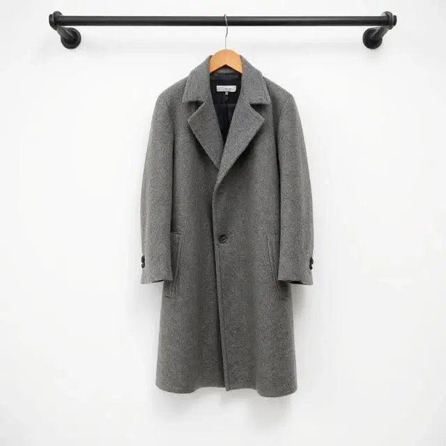 A timeless wool overcoat hanging elegantly
