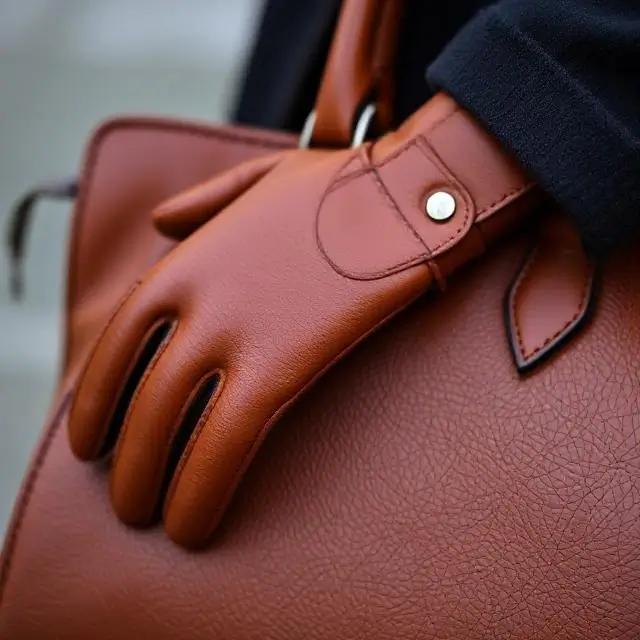 Detail of a leather handbag and glove